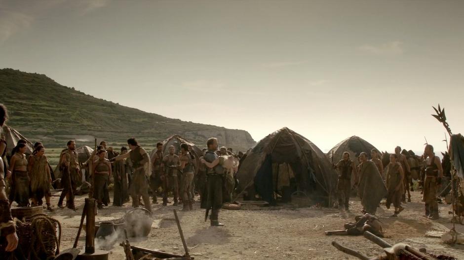 Ser Jorah carries Daenerys to her tent after she collapsed during the healing ceremony.
