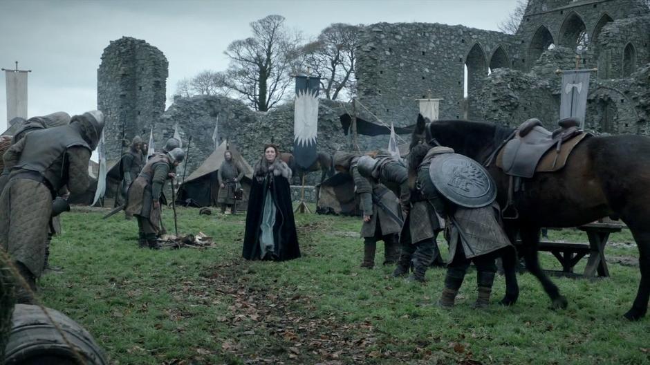 Robb's soldiers bow to Catelyn as she walks trough after learning of her husband's execution.