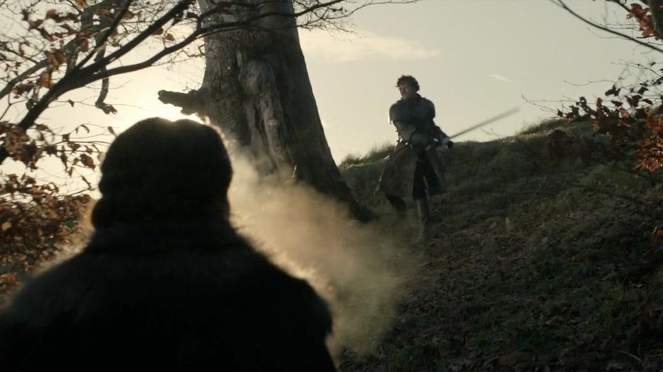 Catelyn approaches Robb while he is whacking a tree with his sword.