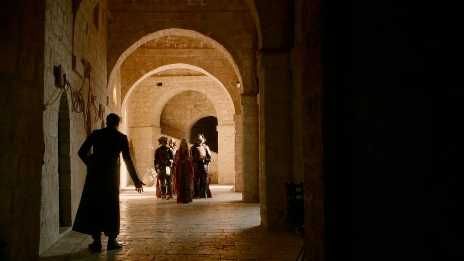 Littlefinger greets Cersei who is walking with her guards.