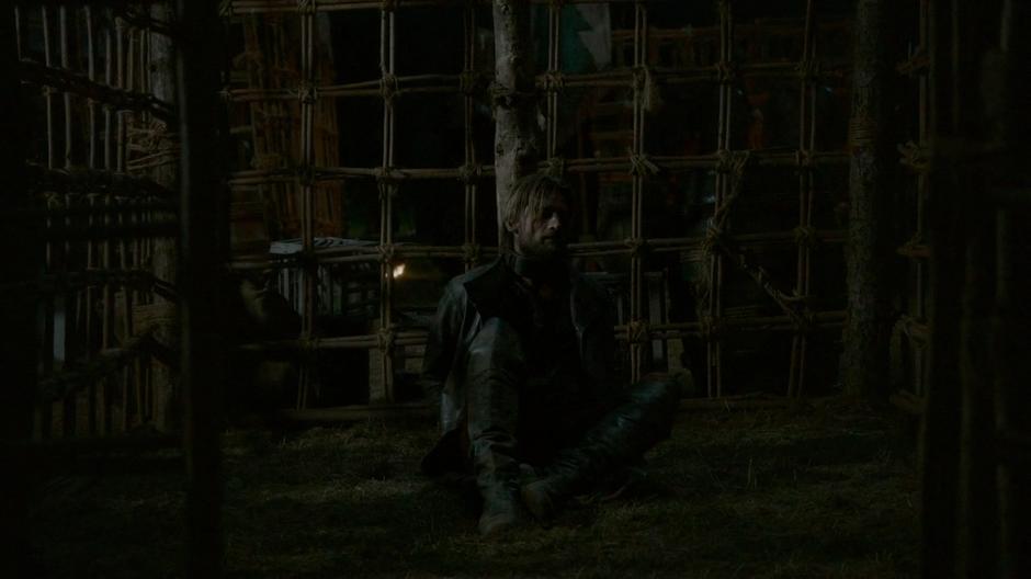 Jaime sits tied up in his cell in camp.