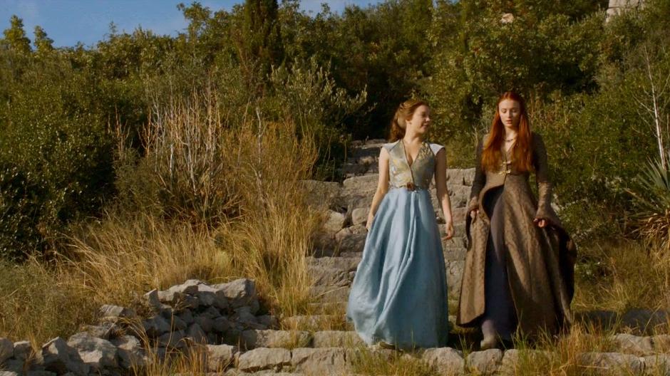 Margaery talks about her sister while walking down some stairs with Sansa.