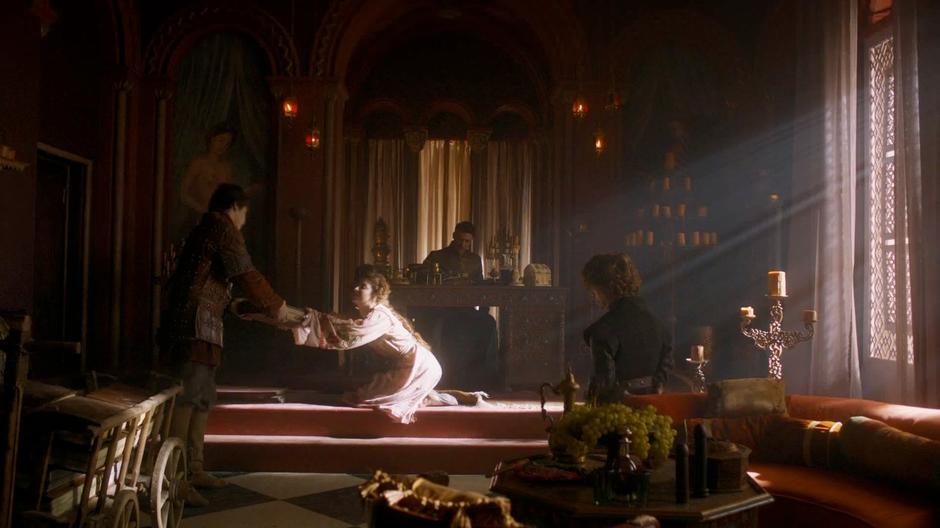 Ros hands Pod the crown's account books while Littlefinger explains his hiding place to Tyrion.