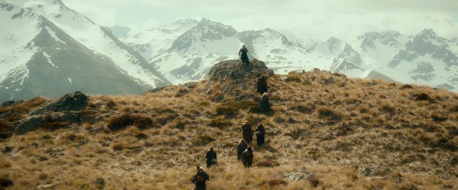 Thorin leads a line of line a 
dwarves refugees up a hillside.