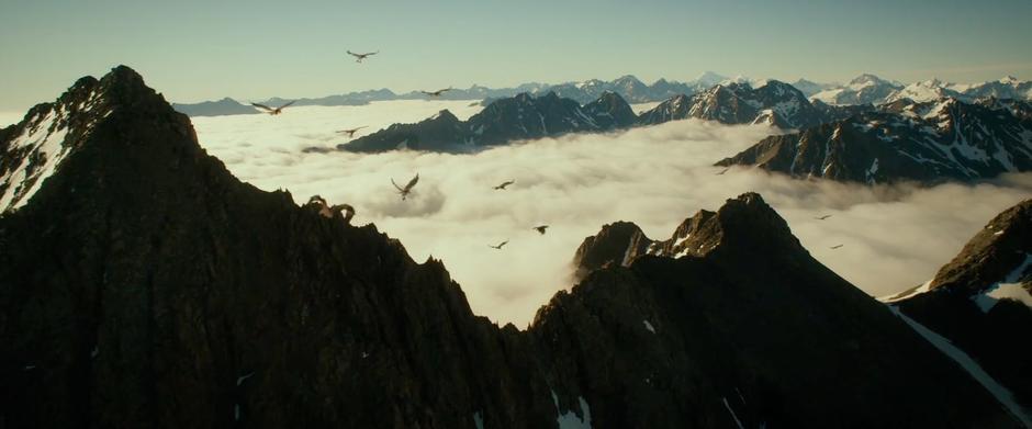 The eagles carry Thorin's company over some peaks in the Misty Mountains.