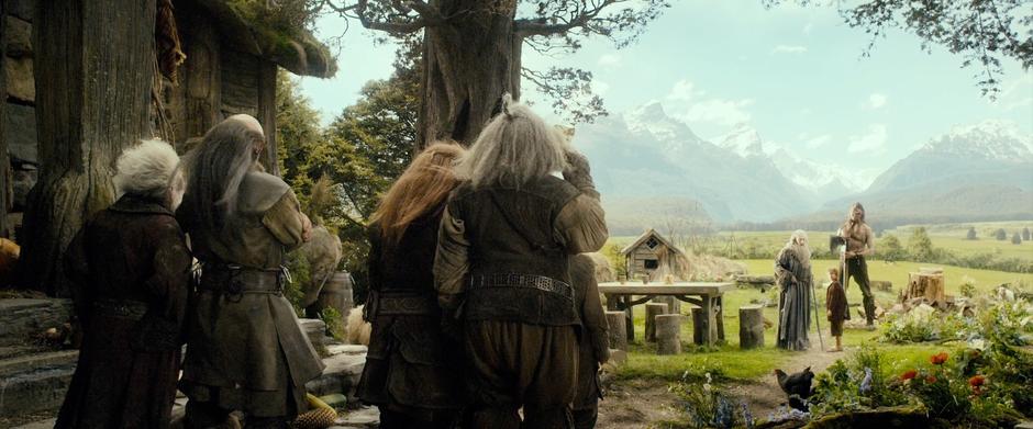 The dwarves gather outside while Gandalf attempts to explain their presence to Beorn.