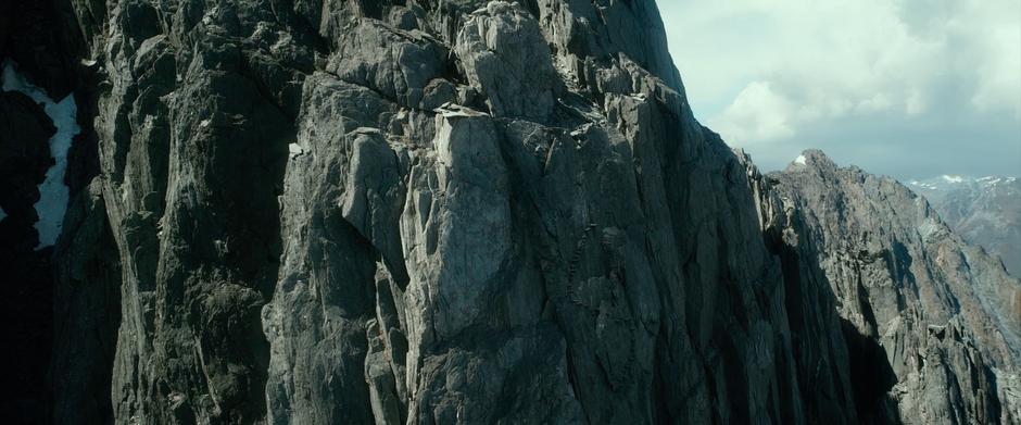 Gandalf climbs a perilous staircase up to the entrance to the High Fells.
