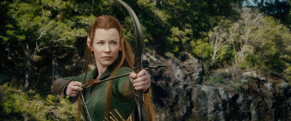 Tauriel points her bow at Legolas who snuck up on her.