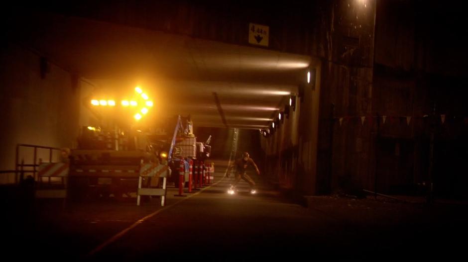 The Flash stops in the tunnel ahead of the criminal's car.