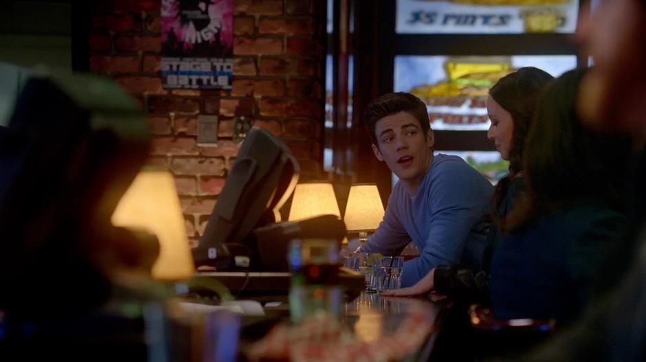 Barry talks to a girl at the bar.