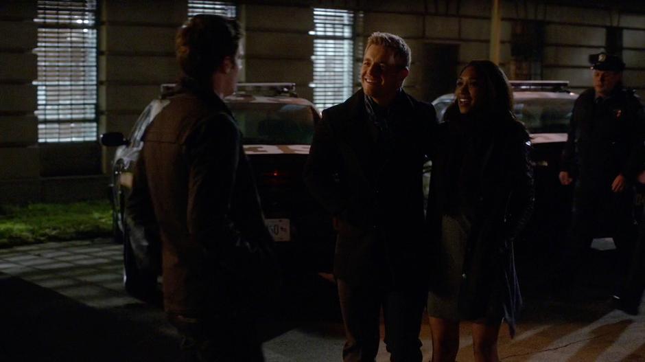 Eddie and Iris talk to Barry outside the station.