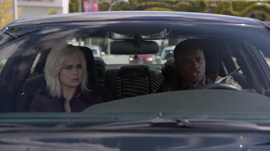 Clive talks to Liv while they drive down the road.