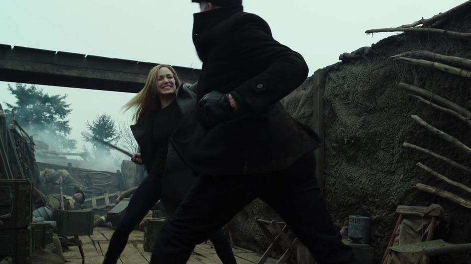 Sara fights Damien Darhk in the trench.