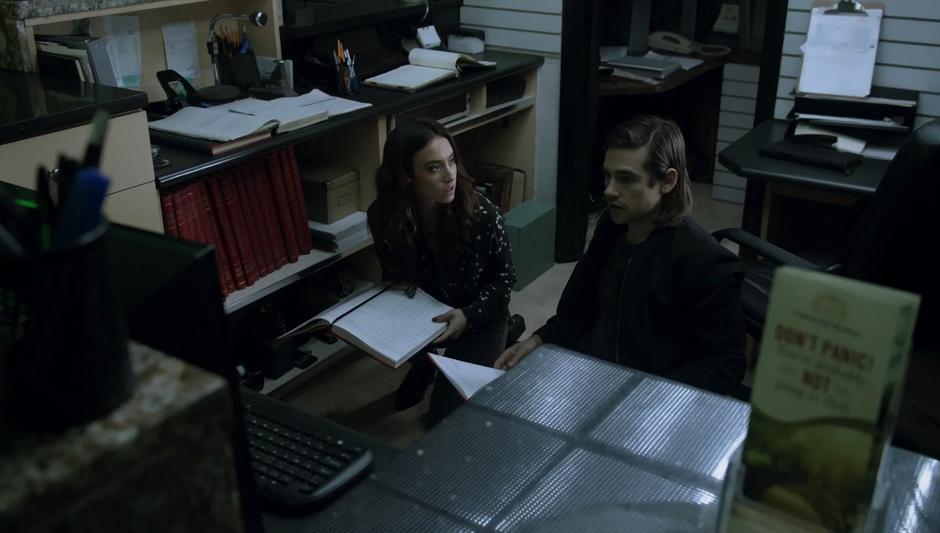 Julia & Quentin look through the records behind the reception desk for clues as to where Julia's shade was taken.