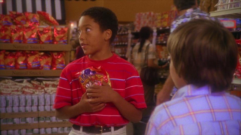Gus holds his candy while Shawn asks for more money.