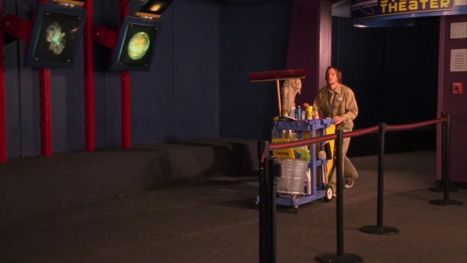 Vernon Stallings pushes his cleaning cart out of the planetarium.