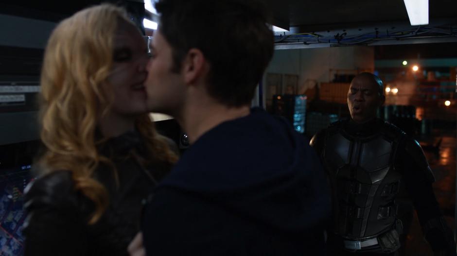 James closes his eyes as Lyra and Winn kiss.