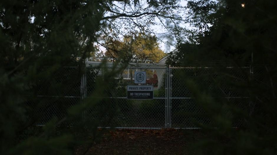 A barbed-wire fence with a no trespassing sign sits where the magical wards around the school original resided.