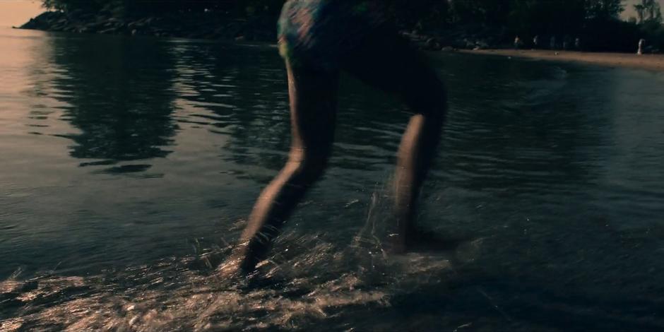 Hannah runs back towards the beach where Offred is waiting.