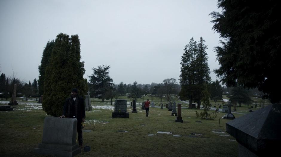 Barry walks away from Joe who is still standing in front of Iris's grave not looking at him.