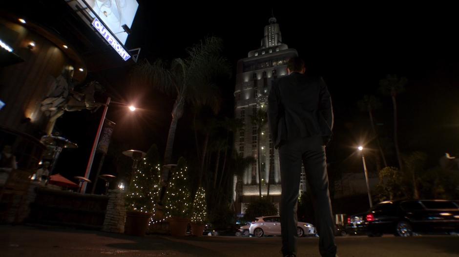 Lucifer watches Candy's car pull out onto the street and head away.