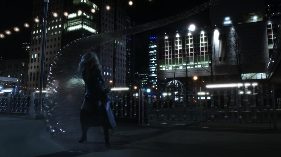 Killer Frost swoops down to the ground on a bridge of ice.