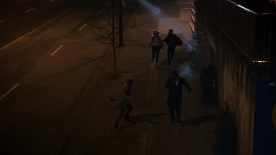 Julian, Joe, Tracy Brand, and H.R. run down the street just ahead of one of the ice blasts from the sky.
