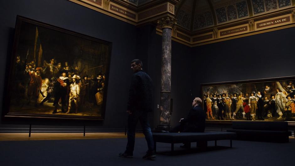 Will looks around the space before sitting down on the bench with Chroome in front of Rembrandt's The Night Watch.