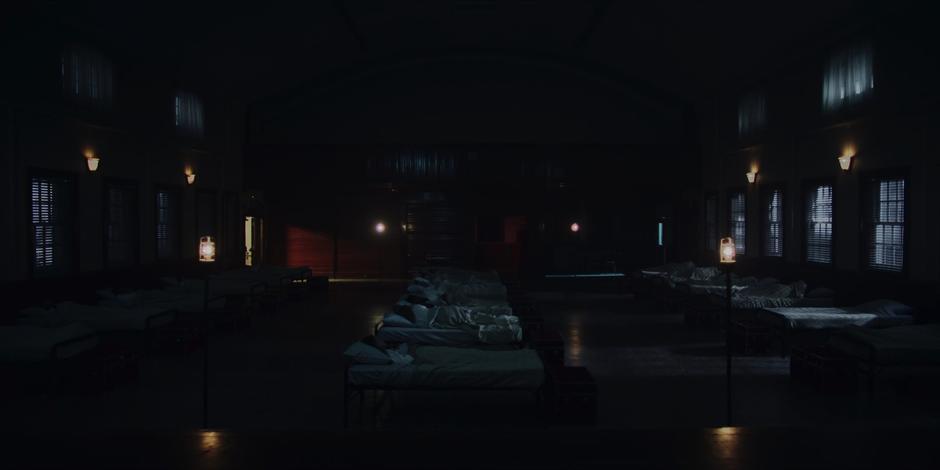 The trainees lay in their beds in a darkened room.