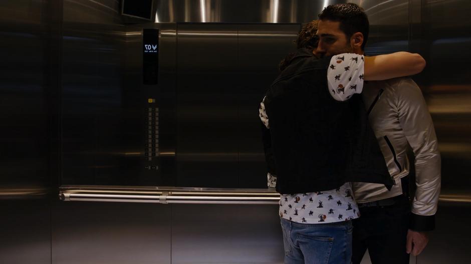 A young man in the elevator hugs Lito before thanking him.