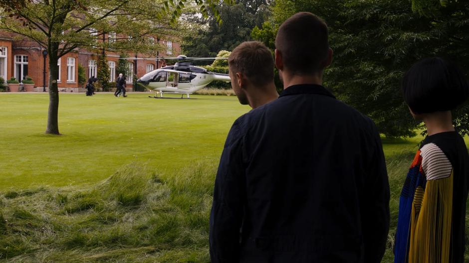 Wolfgang, Will, and Sun watch as Whispers and his family are bundled into a waiting helicopter by several armed guards.