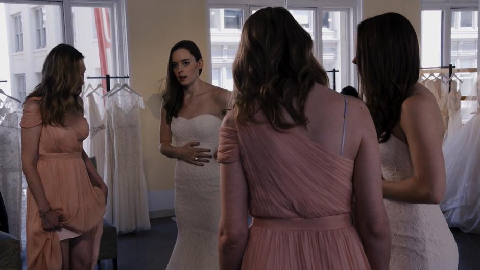 Teagan adjusts her dress to avoid answering Nomi's question about what their father said.