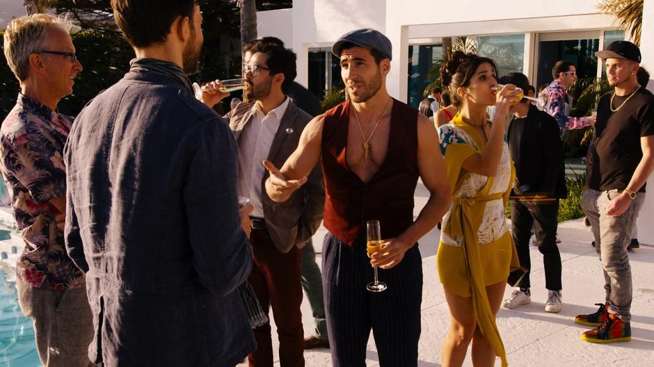 Hernando and Dani take drinks while Lito asks a question after Kit Wrangler told him that he would be staring in the film with Blake Huntington.