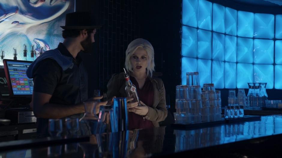 The bartender looks at Liv as she reacts to the pepper vodka.