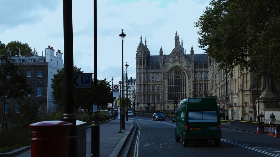 The van drives down the street towards the Palace of Westminster.