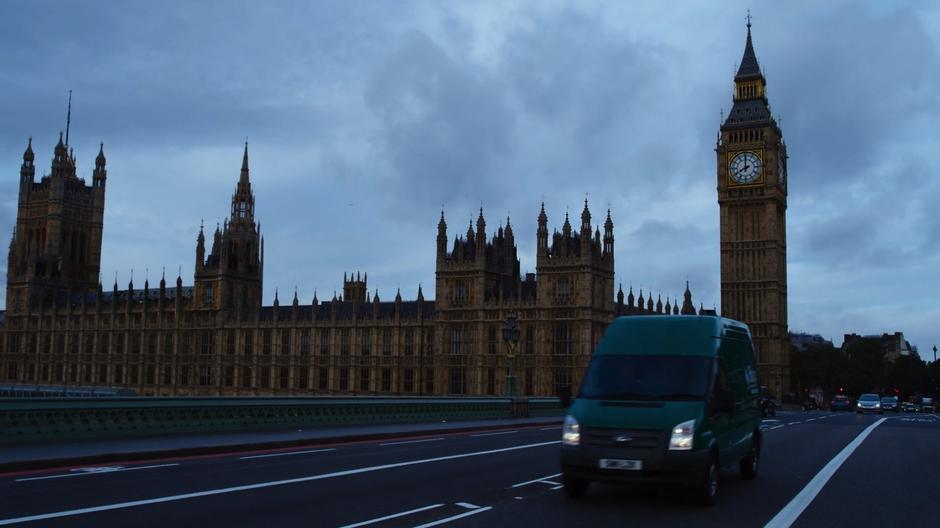 Capheus drive the BPO van across the bridge with the Palace of Westminster in the background.