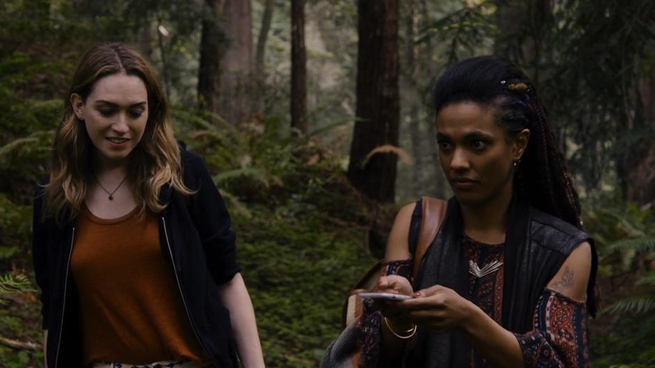 Nomi follows Amanita as she uses her phone's GPS to locate the cabin.