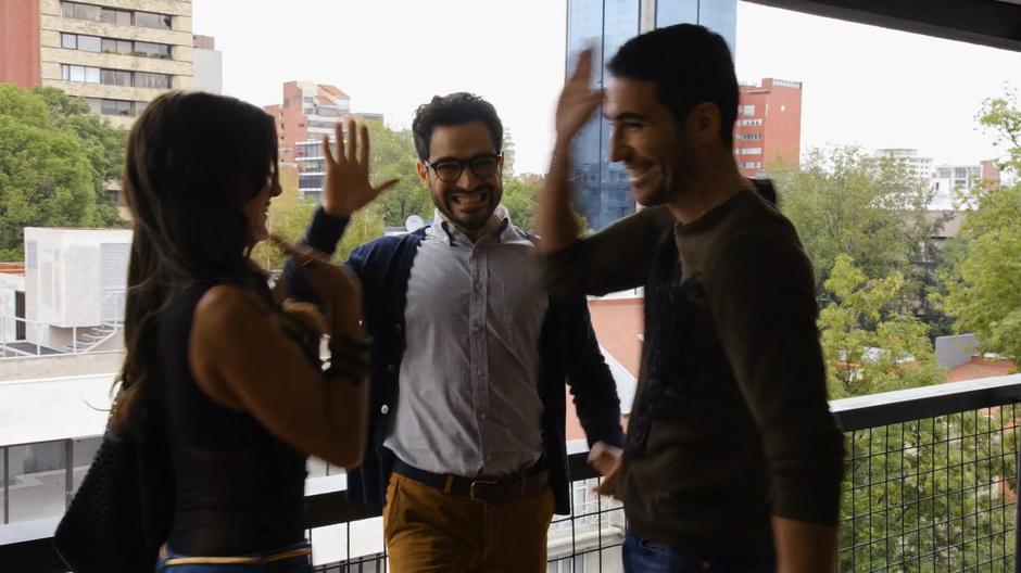 Dani, Hernando, and Lito all high five like a bunch of dorks after deciding to get the apartment.
