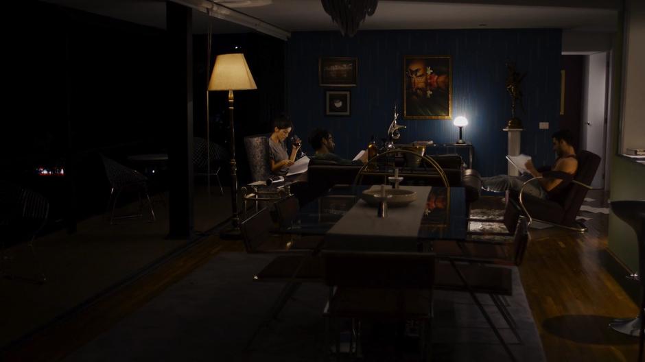Dani, Hernando, and Lito sit in the living room at night reading through the scripts.