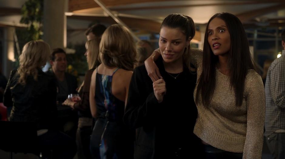 Maze stands with her arm around Chloe's shoulder and roles her eyes at the woman who just walked away.