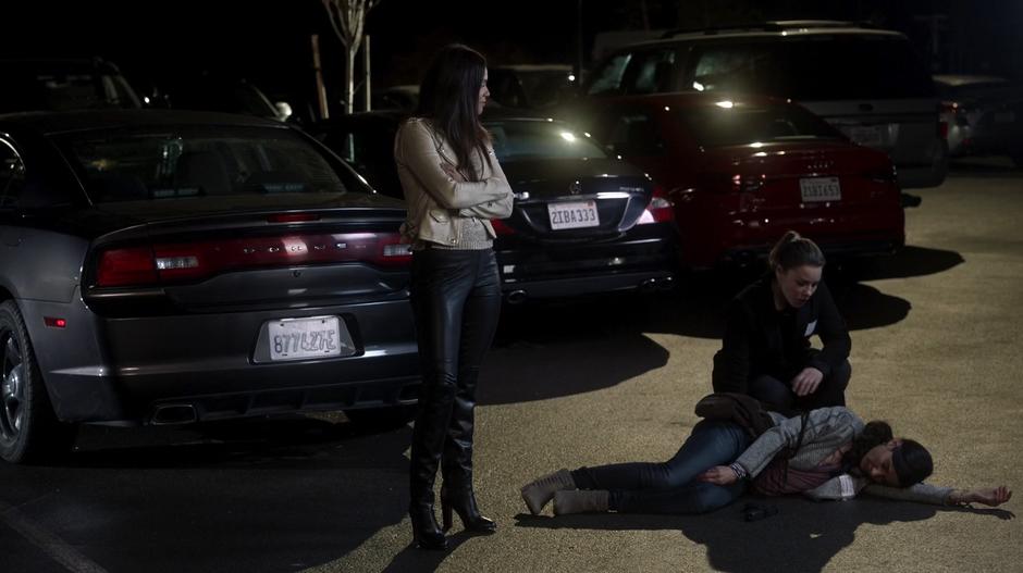 Chloe crouches down over the unconscious Madison while Maze looks down with pride on her handiwork.