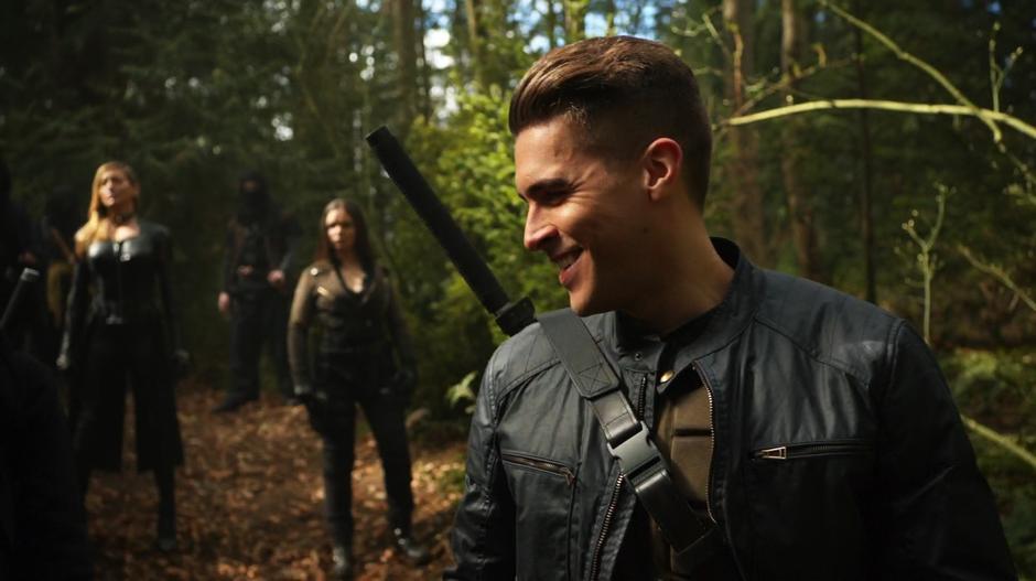 Chase smiles down at the group while Black Siren and Evelyn Sharp stand in the back with several of Talia's people.