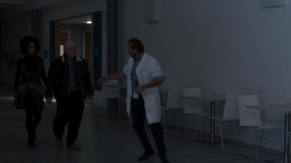 Nicolas leads Bill and Nardole into the CERN cafeteria.