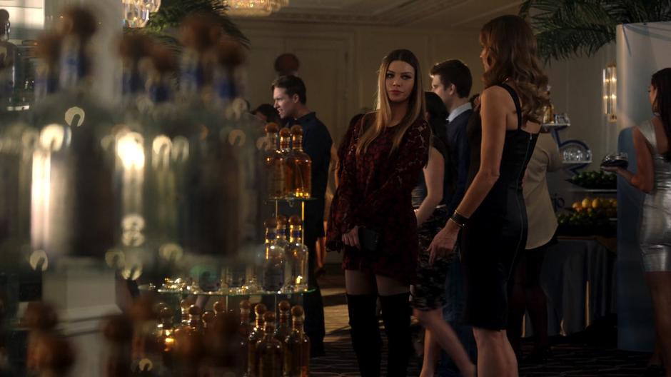 Chloe looks around the party with Charlotte while looking fine as hell.