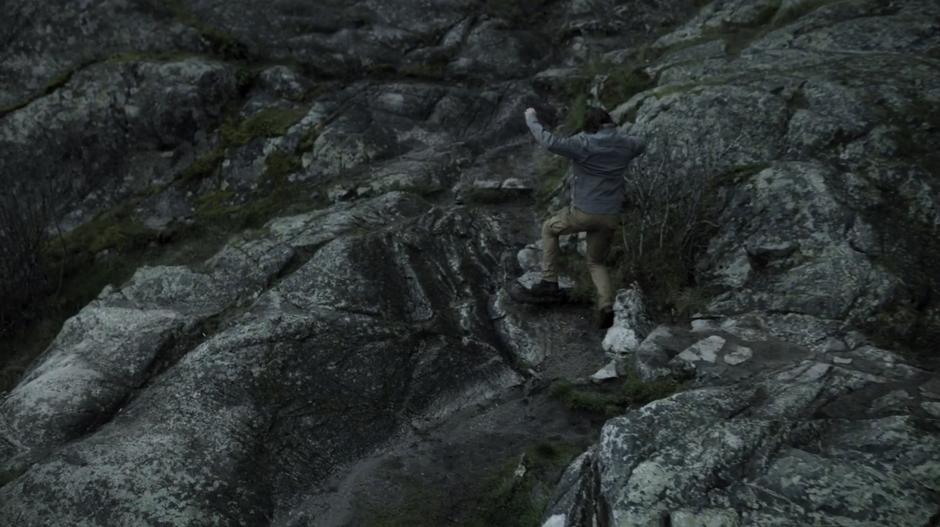 Oliver runs across the rocks fleeing the prison where Konstantin Kovar had him locked up.