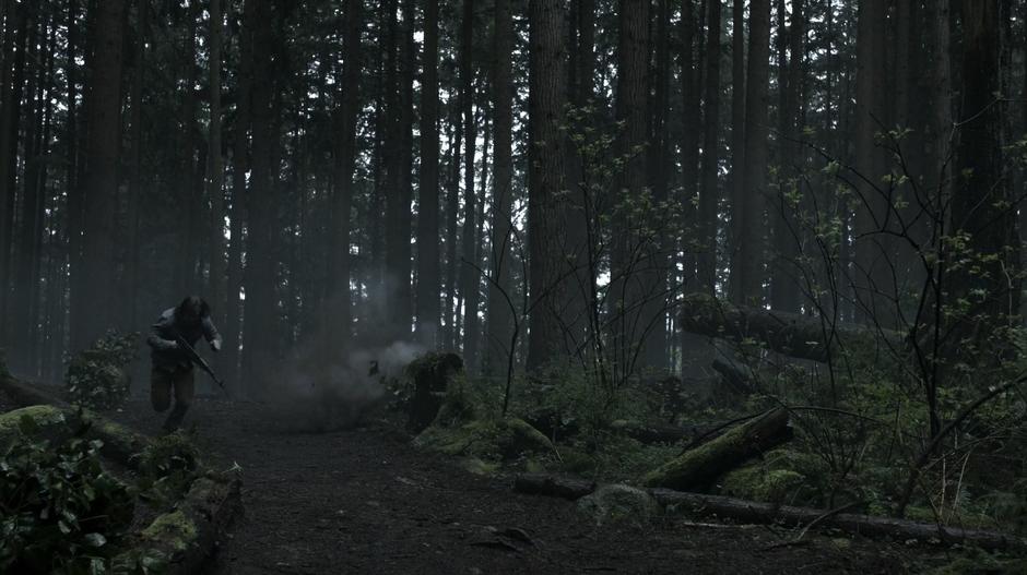 Oliver runs through the woods while ducking from fire from Konstantin Kovar's helicopter.