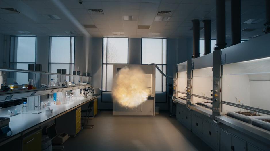 The explosion engulfs the testing chamber and begins to spread throughout the lab.