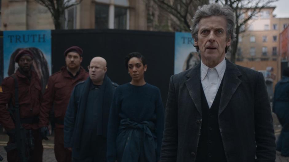 The resistance members, Nardole, Bill, and the Doctor watch people recover from the memory control.