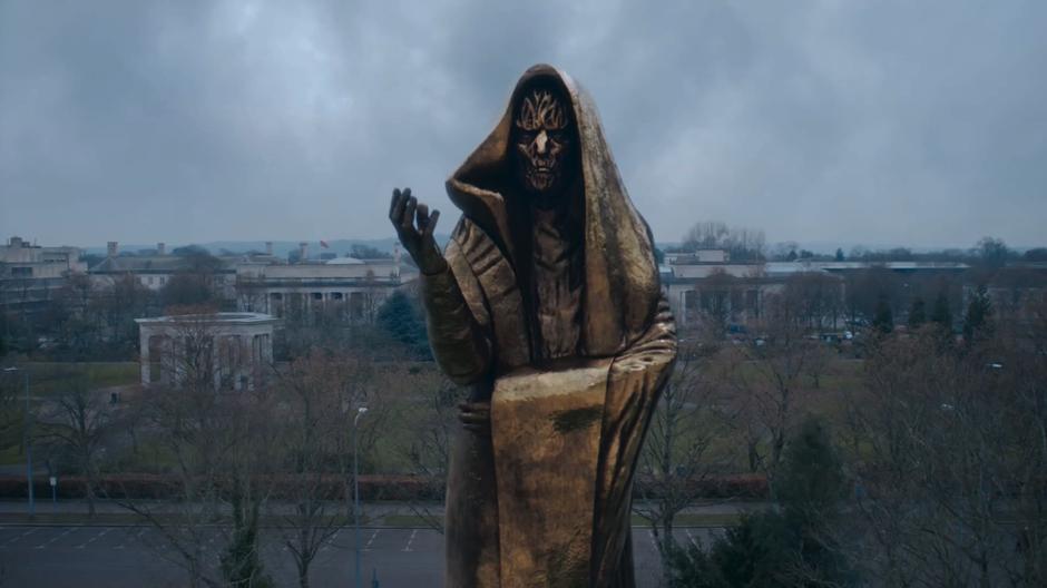 The monk statue towers over the front of the university.