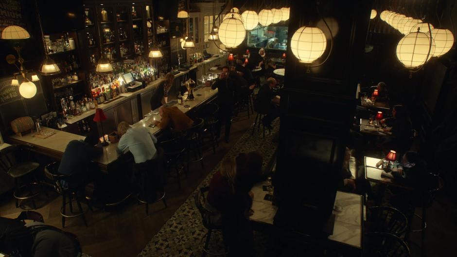 Azazel takes a drink while the restaurant patrons die around him.